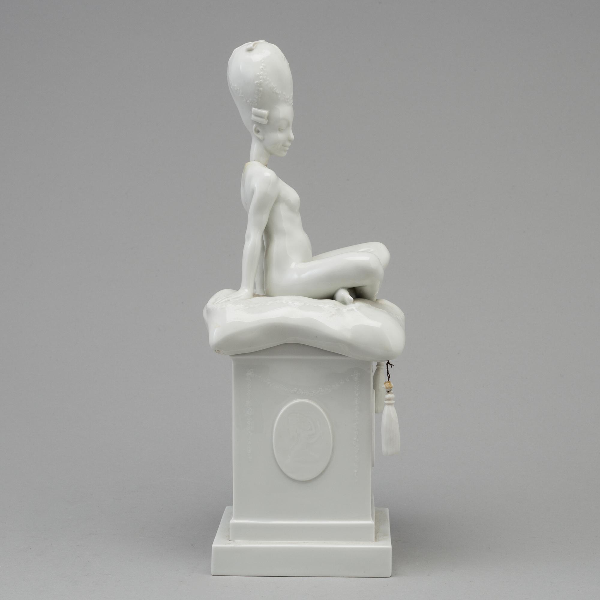 A white glazed Royal Copenhagen porcelain nodding head figure, Denmark, early 20th Century. Not first quality.