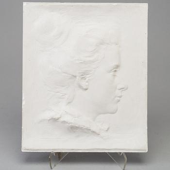 A signed plaster relief by Harald Sörensen-Ringi, dated 1895.