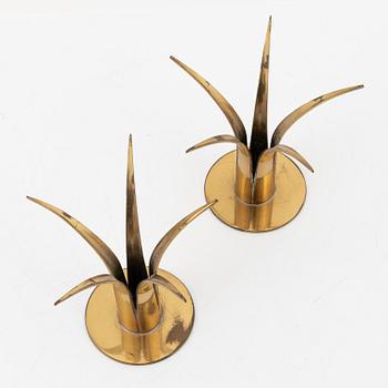 Ivar Ålenius-Björk, a set of eight brass candleholders, including 'Liljan', from Ystad Metall, mid 20th Century.