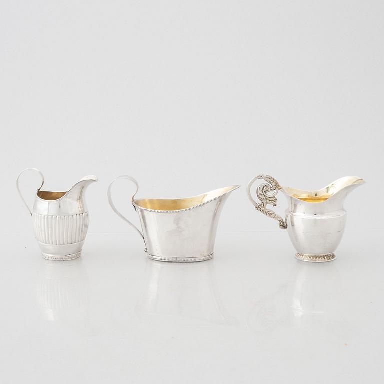 Three early 19th century Empire silver creamers,.