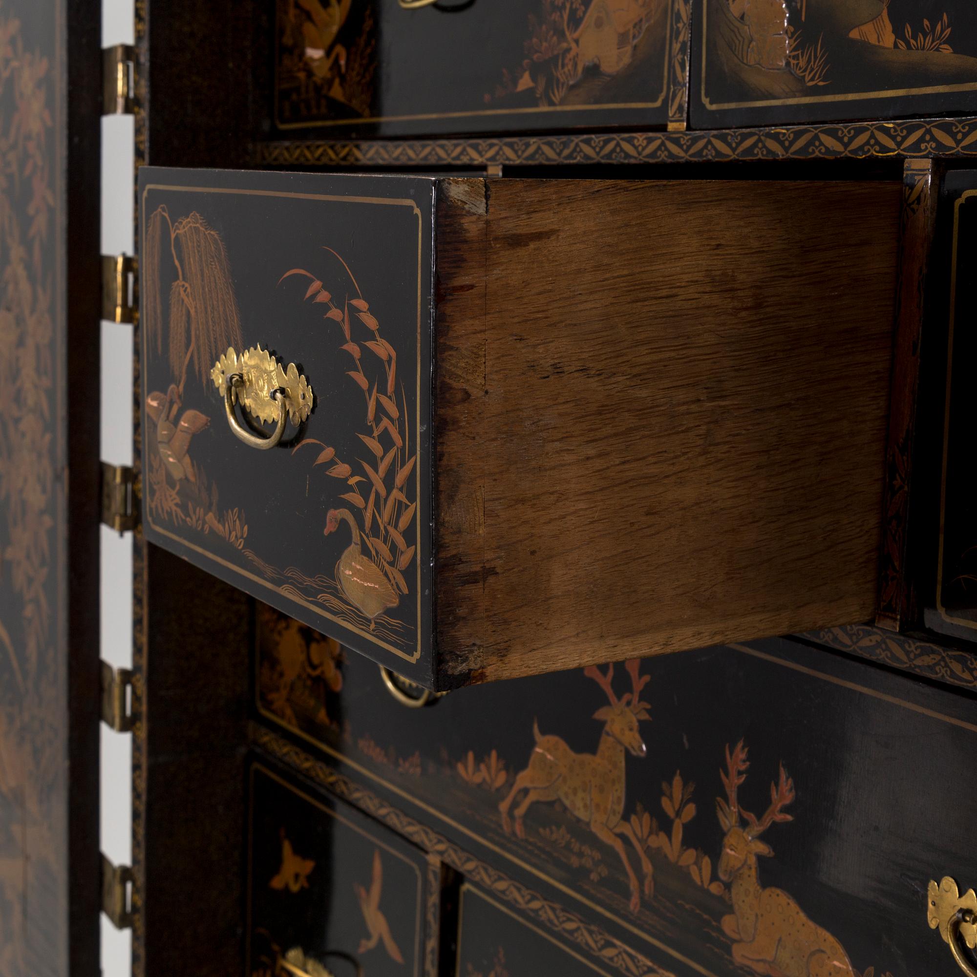 AN early 18TH CENTURY PROBABLY ENGLISH Japanned laquer cabinet on stand.