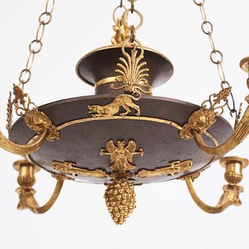 An ormolu and painted bronze four-light Empire chandelier, early 19th century.