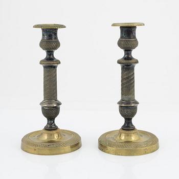 A pair of bronze Empire style candlesticks, 20th Century with older parts.