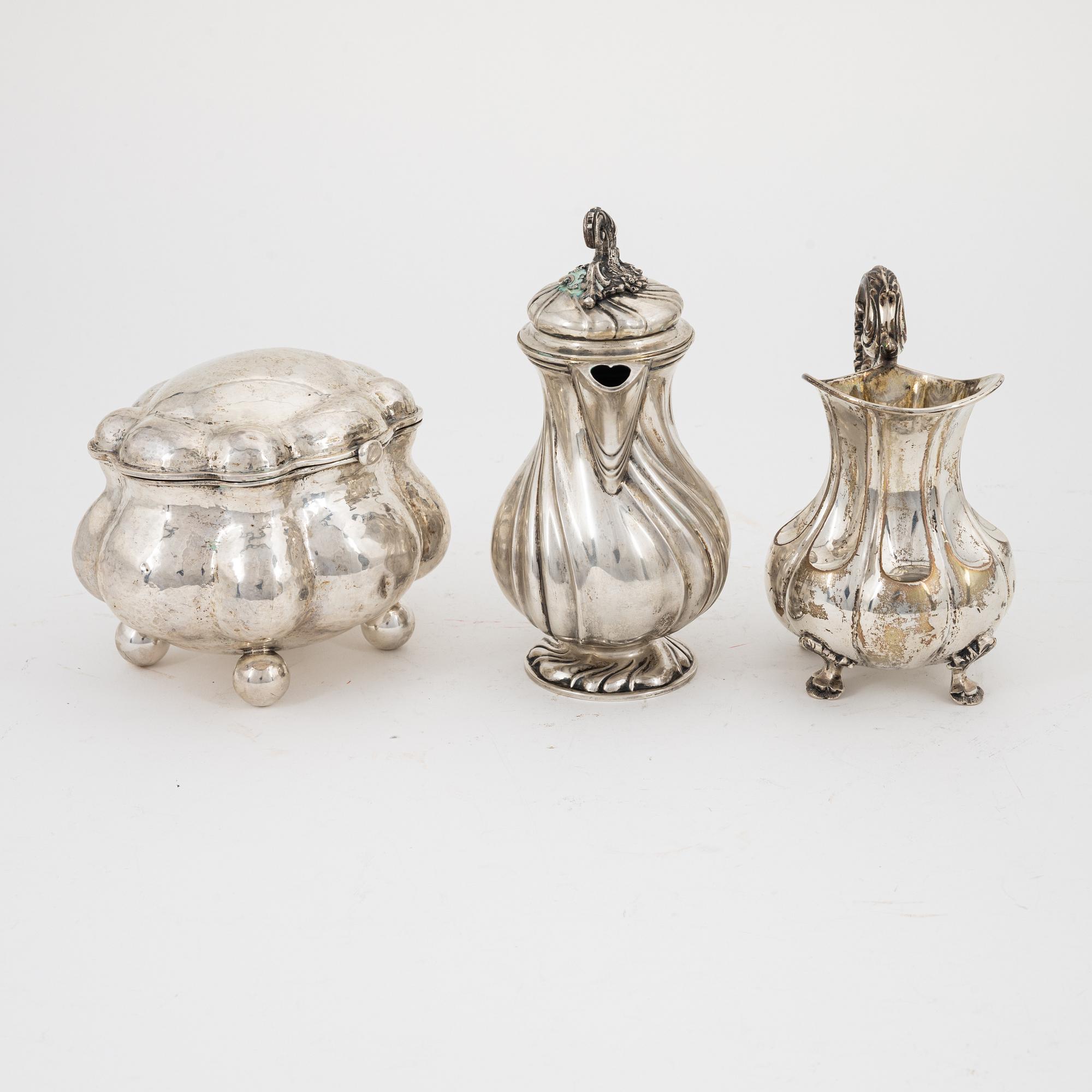A Rococo style silver sugarbox and two creamers, including Lars Larsson ...