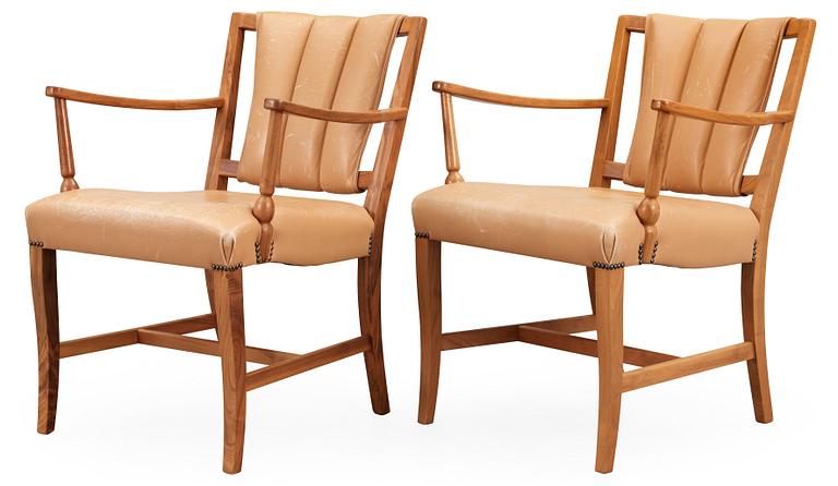 A pair of Josef Frank walnut and light brown leather armchairs, Svenskt Tenn.