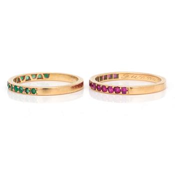 Two 18K gold rings set with faceted rubies and emeralds.