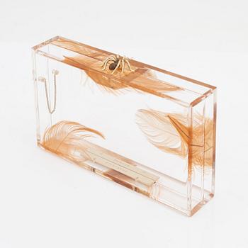 Charlotte Olympia, a transparent clutch with feathers and a spider.