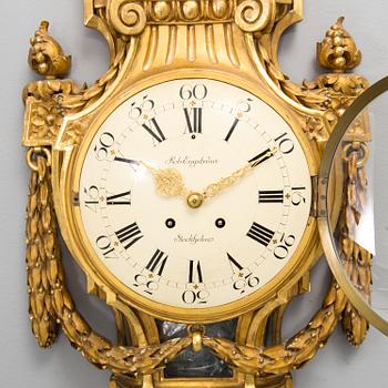 A wall clock in gustavian style, marked Rob. Engström, Stockholm.