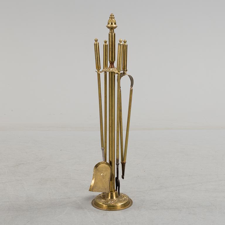 A set of 4 brass fire utensils with stand, 20th Century.