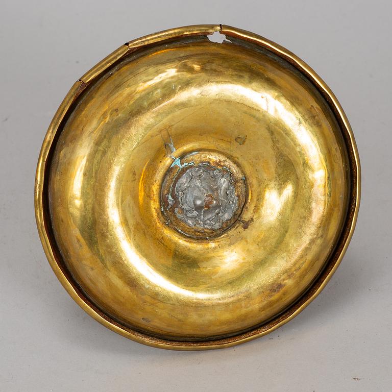 A 19th century brass night light holder.