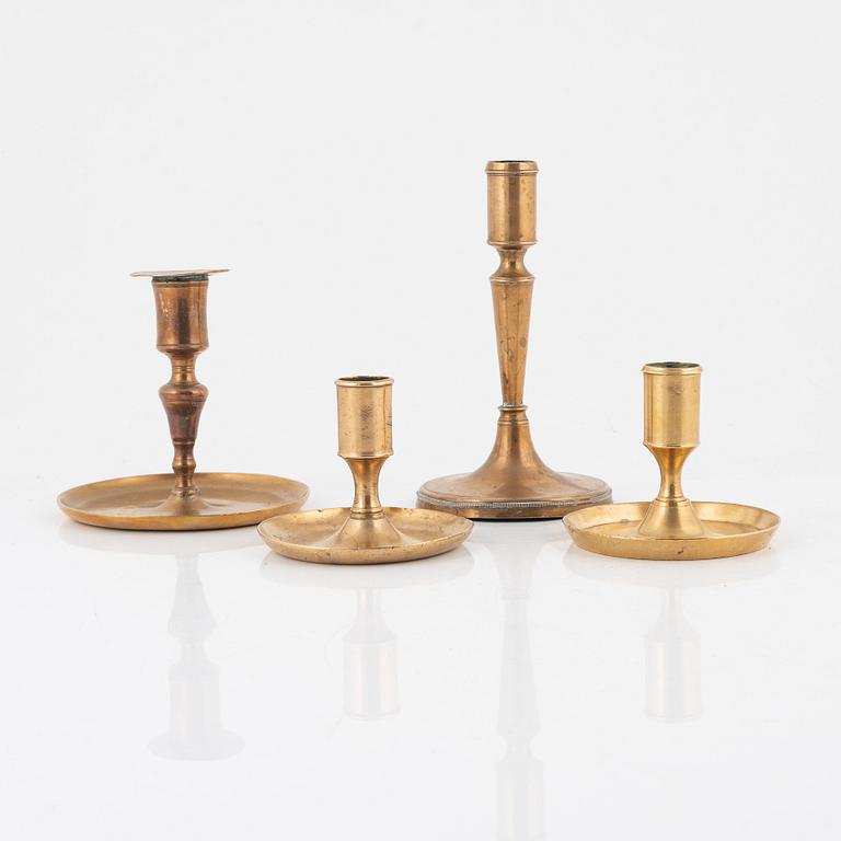 Four brass candlesticks, 18th-19th Century.