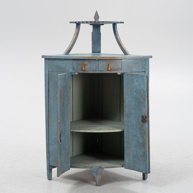 A painted corner cabinet, late 19th century.