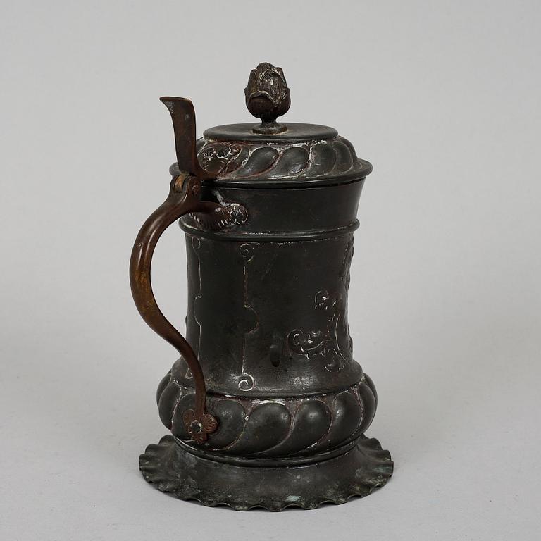 An 18th century copper mug.