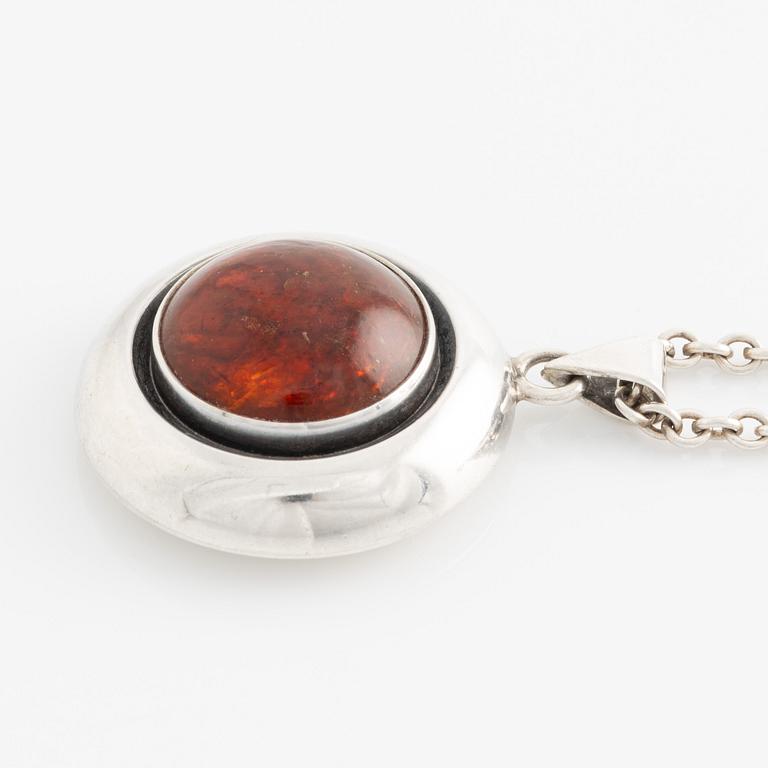 Nils Erik From, pendant and brooch, silver and amber.