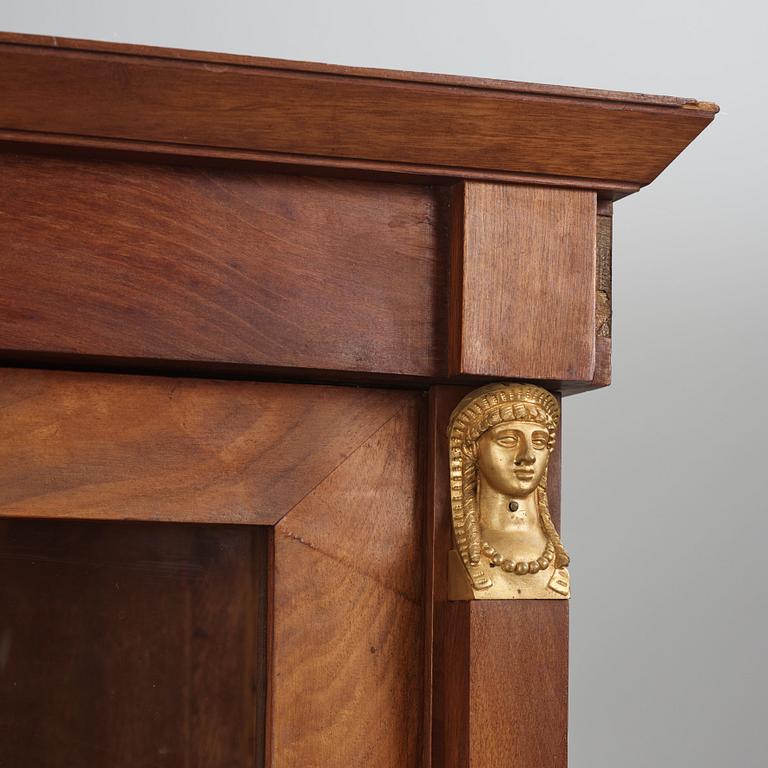A French Empire mahogany and gilt-bronze mounted bibliothèque, early 19th century.