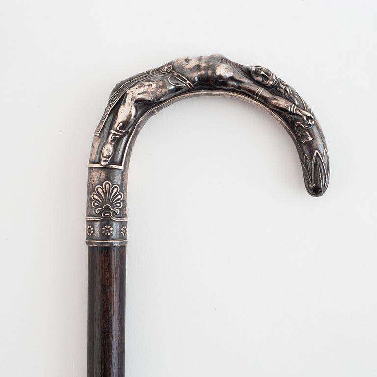 A mid-20th century foil and a walking stick.