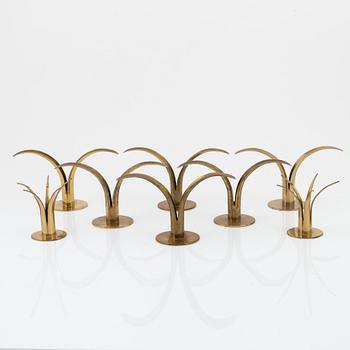 Ivar Ålenius-Björk, a set of eight brass candleholders, including 'Liljan', from Ystad Metall, mid 20th Century.