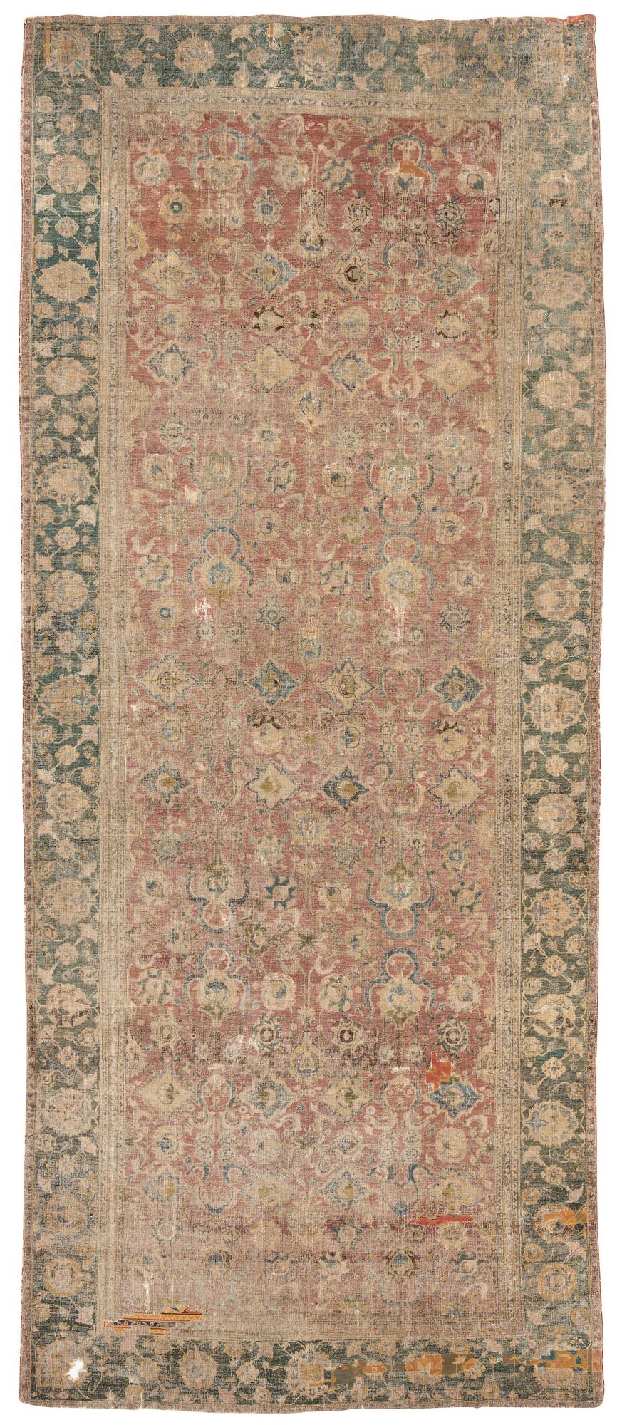 A safavid 'Spiral vine' Esfahan carpet, central persia, mid to second haft of the 17th century. Ca 562 x 231 cm.