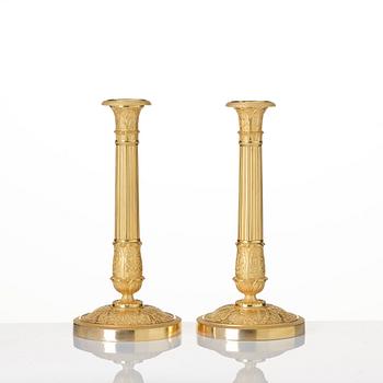 A pair of French Empire ormolu candlesticks, Paris, early 19th century.