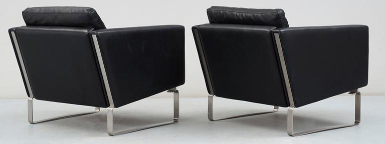 A pair of Hans J Wegner steel and black leather 'CH-101' easy chairs, Carl Hansen & Son, Denmark.