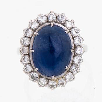 A RING, cabochon cut star sapphire, brilliant cut diamonds, 18K white gold.