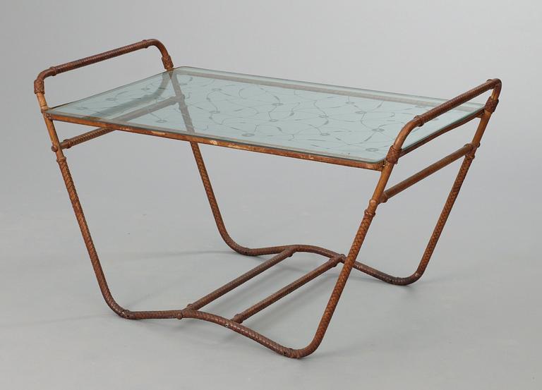A tea table, 1940's-50's, metal frame, covered in brown leather straps, decorated glass top.