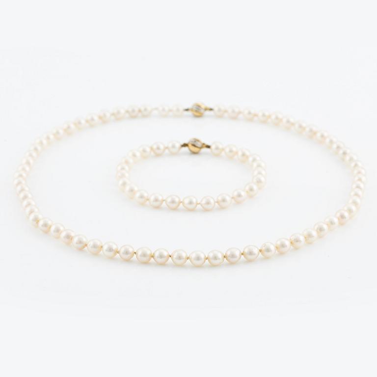 Necklace & bracelet, cultured pearls with 18K gold clasp and small diamonds.