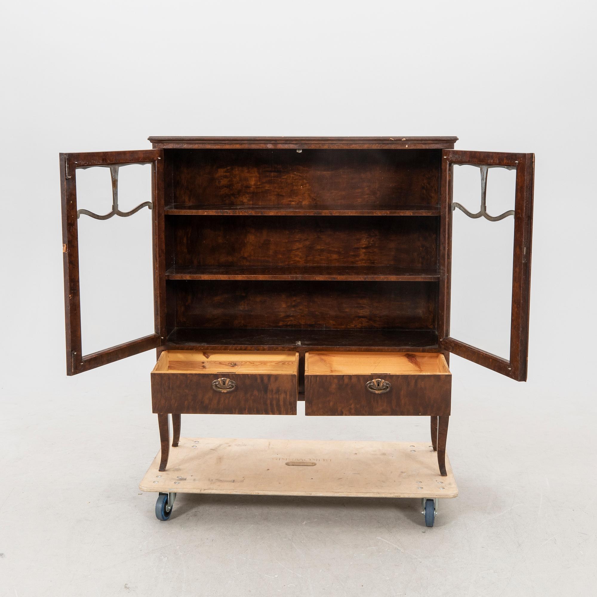 A 1920s  stained beech display cabinet.