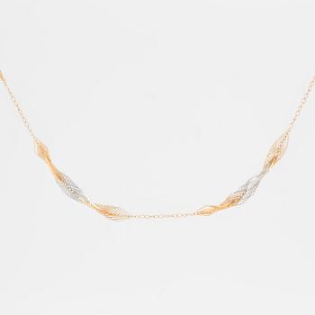 An asymmetrical gold necklace.