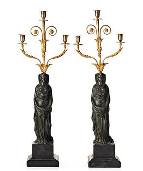 123. A pair of French Empire early 19th century three-light candelabra.