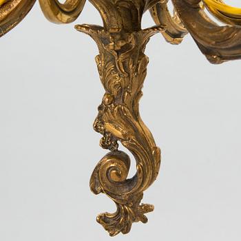 A late 19th-century 12-arm bronze chandelier.