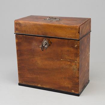 A mid 19th century mahogany veneered box with three glass bottles.