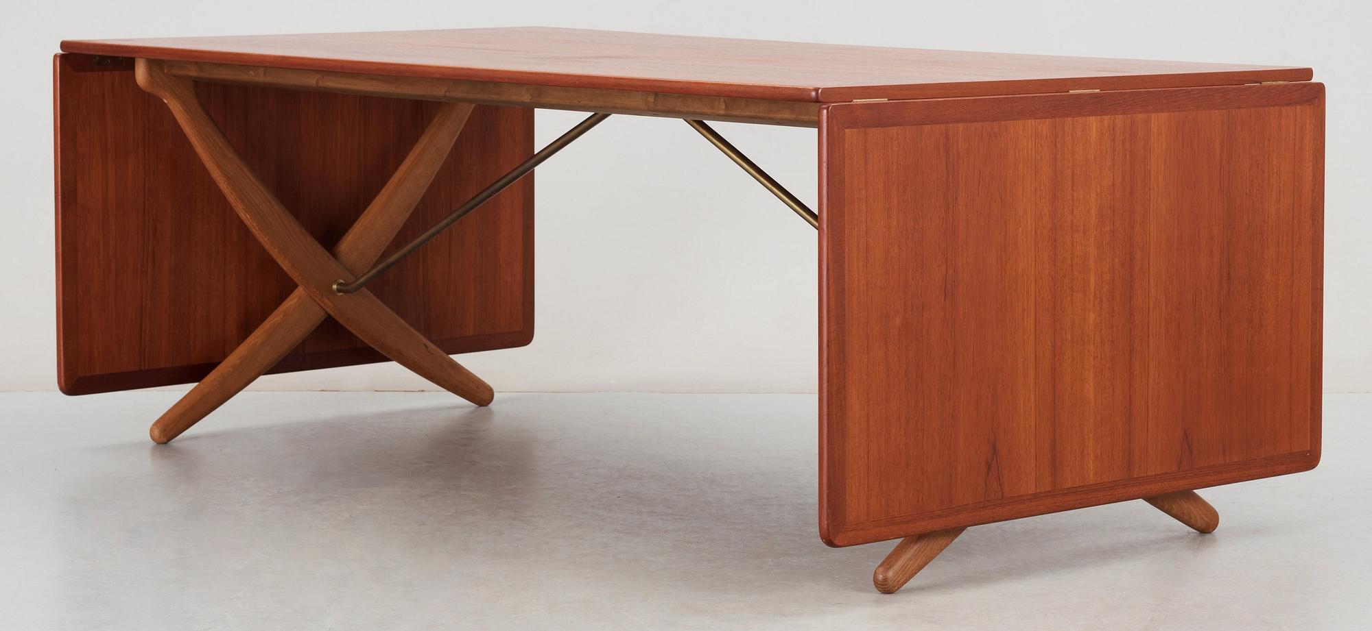 A Hans J Wegner teak and oak sabre leg dinner table by Andreas Tuck, Denmark 1950-60's.