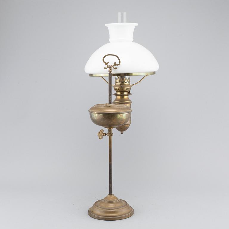 A table paraffin lamp, marked "Kosmos Brenner", around year 1900.