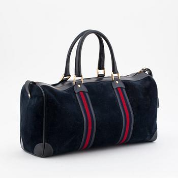 GUCCI, a blue suede and leather weekendbag.