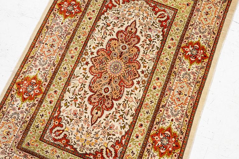 A Hereke silk rug, West Anatolia, c. 107 x 69 cm.