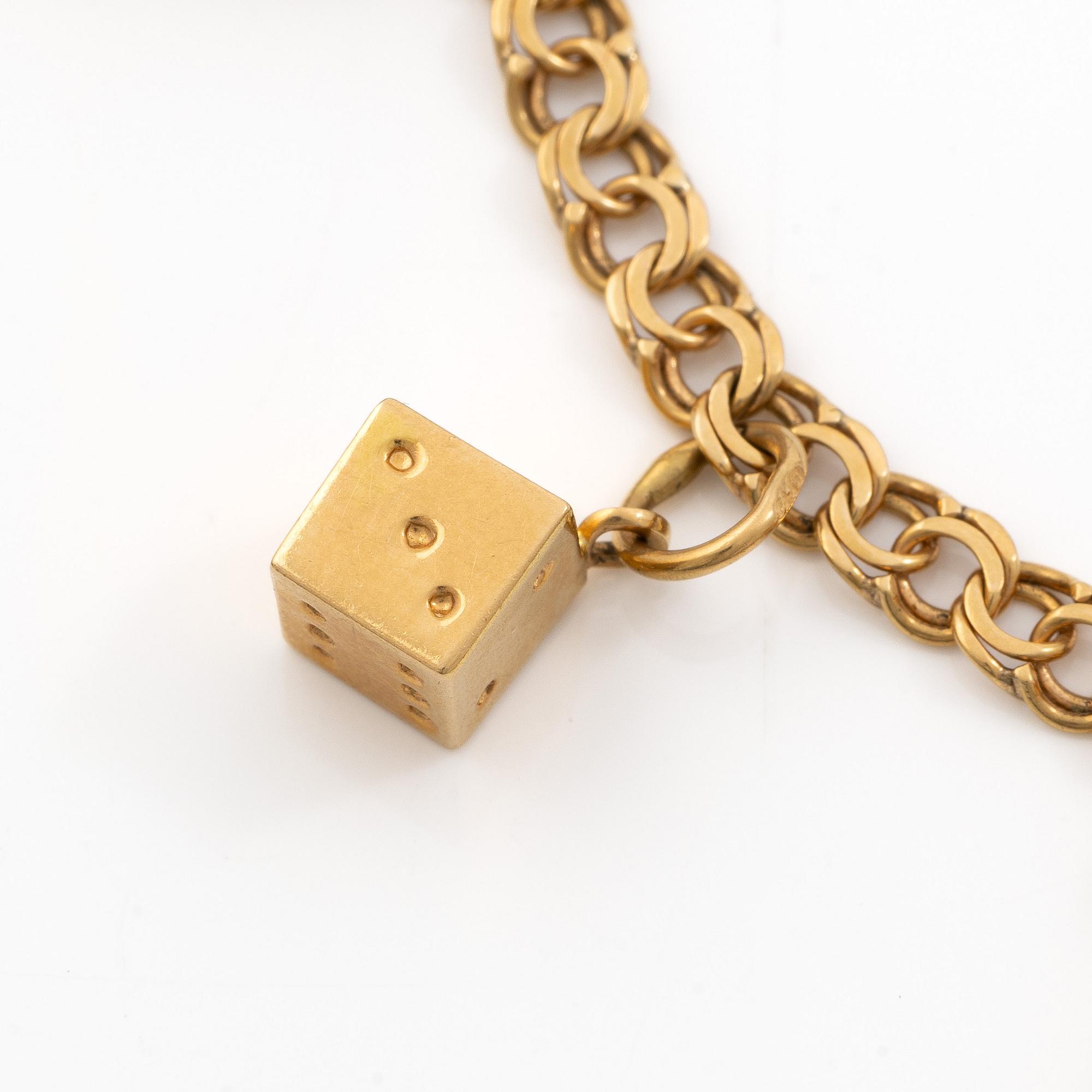 Bracelet 18K gold with five charms.