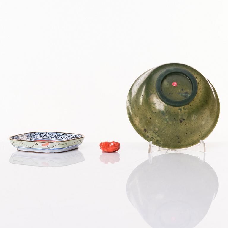 A Chinese enamel on copper coaster, a green stone bowl and a small stone figure, China, Qing dynasty and 20th century.