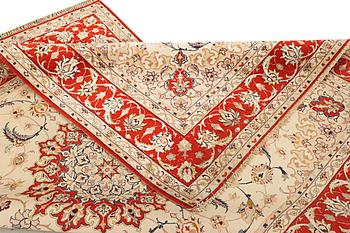 A semi-antique part silk Isfahan rug, a. 238 x 156 cm.