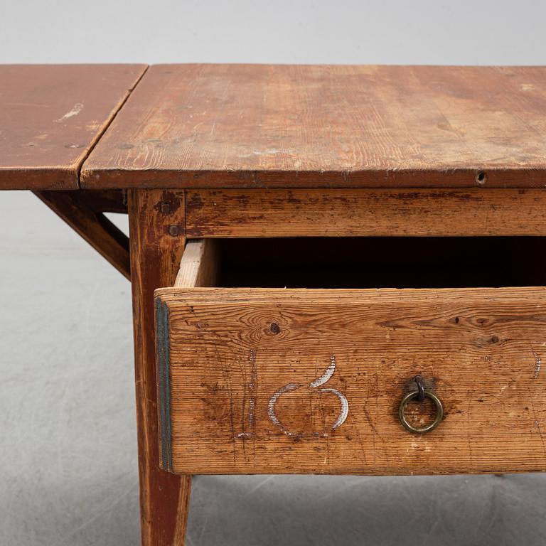 A 19th Century table with drop leaves.