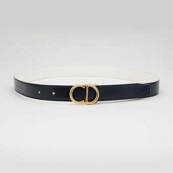 CHRISTIAN DIOR, a reversible blue and white belt with exchangeable belt buckle.