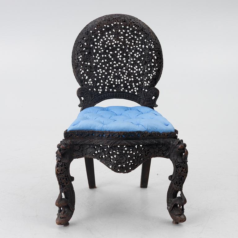 A carved 'blackwood' armchair.  bombay presidency circa 1880.