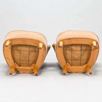 A pair of mid-20th-century armchairs.