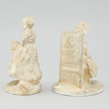 two plaster figurines, signed.