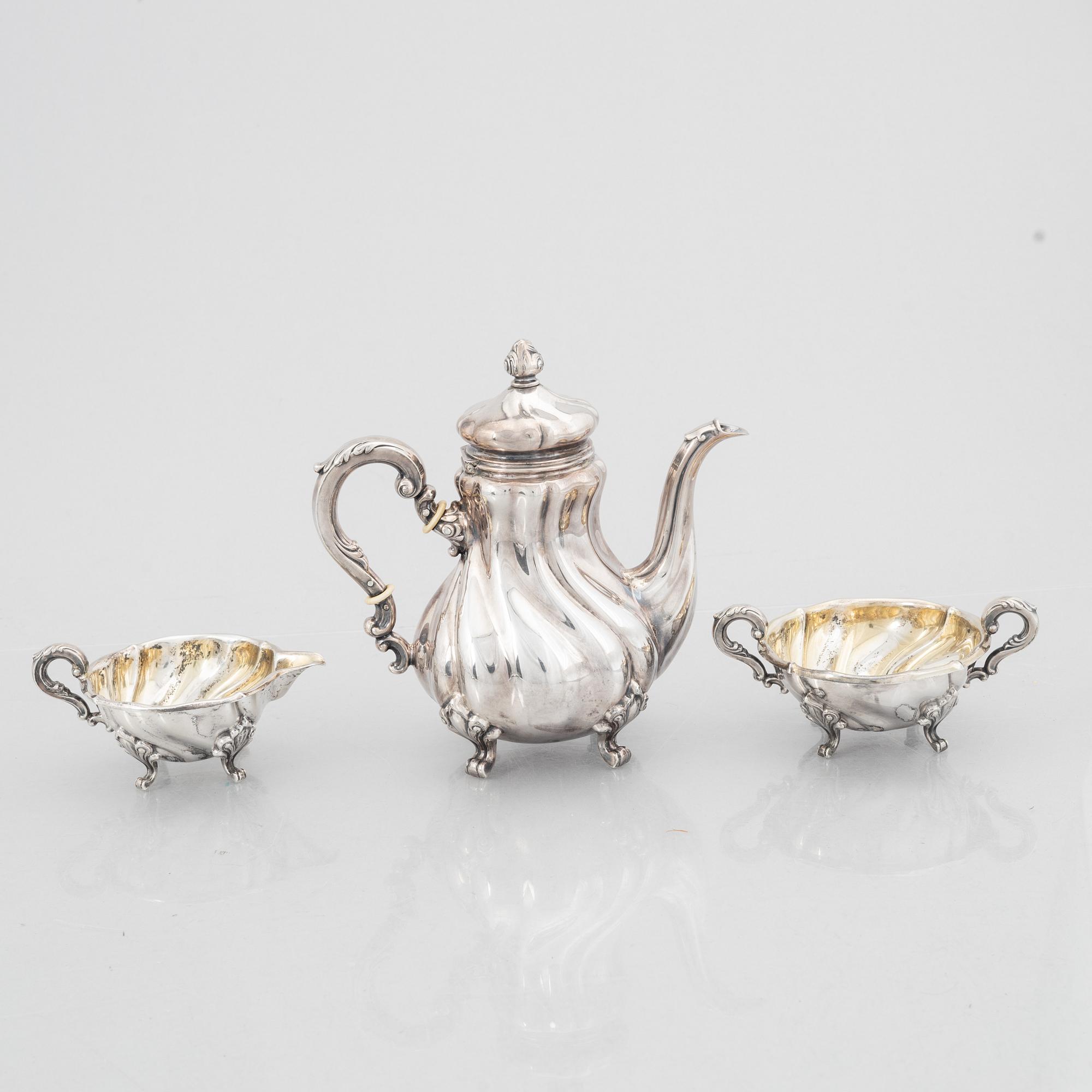 A Rococo Style Silver Coffee Pot, Creamer and Sugar Bowl, 20th Century, Swedish import mark.