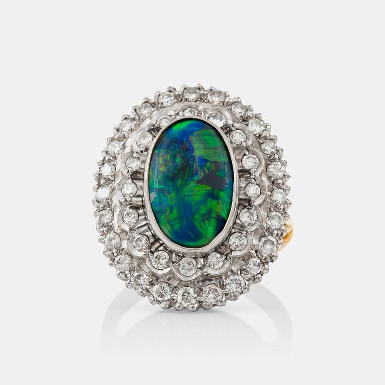 An opal and brilliant-cut diamond ring. Total carat weight circa 0.80 ct.