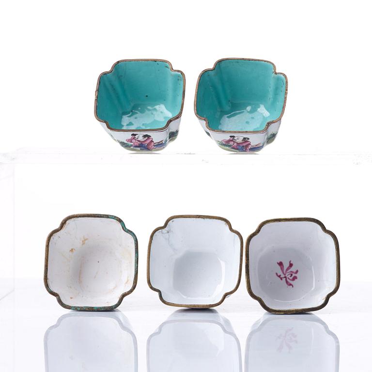 A set of five enamel on copper tea cups and a dish, Qing dynasty, circa 1800.