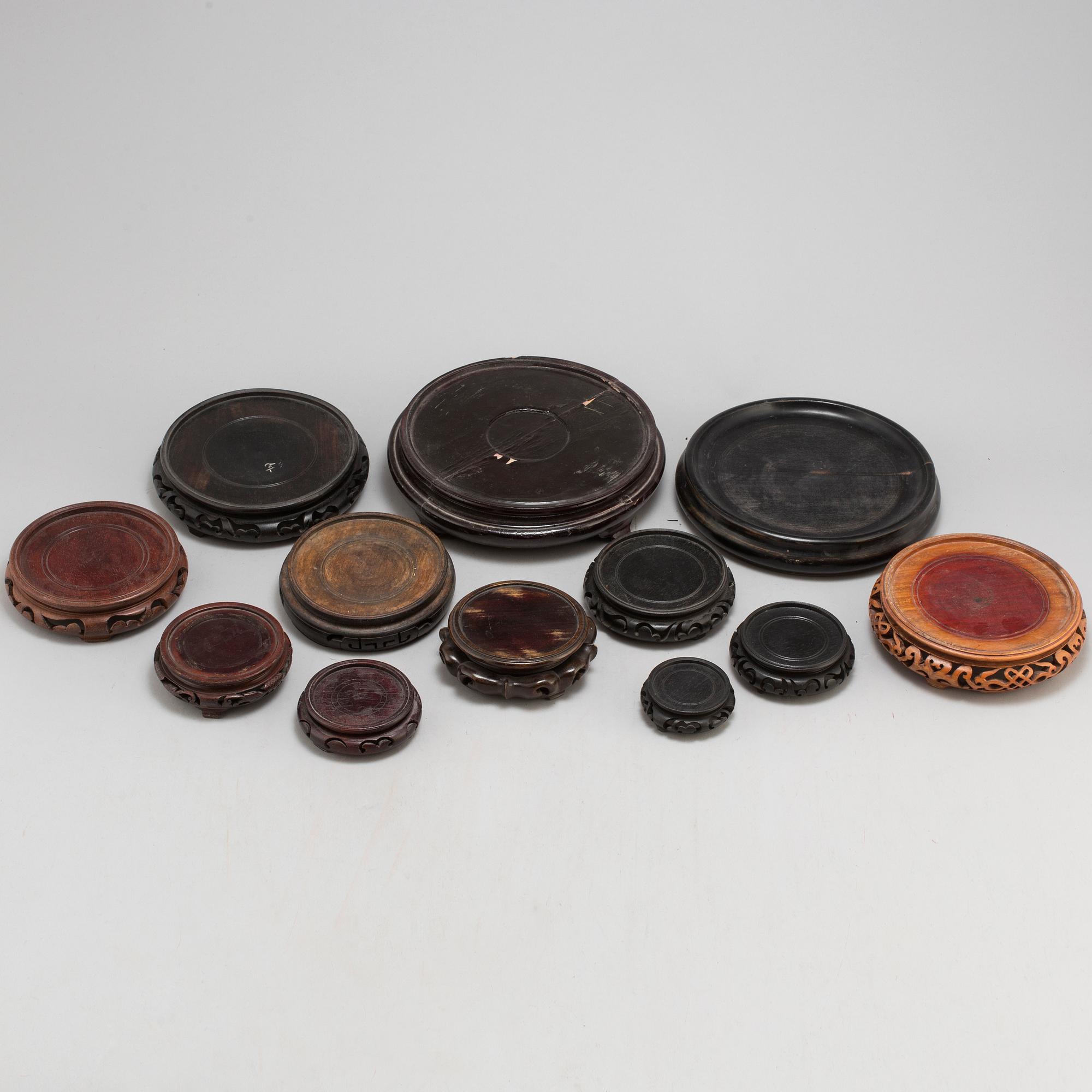 A set of 12 Chinese wooden stands, 19th and 20th Century.
