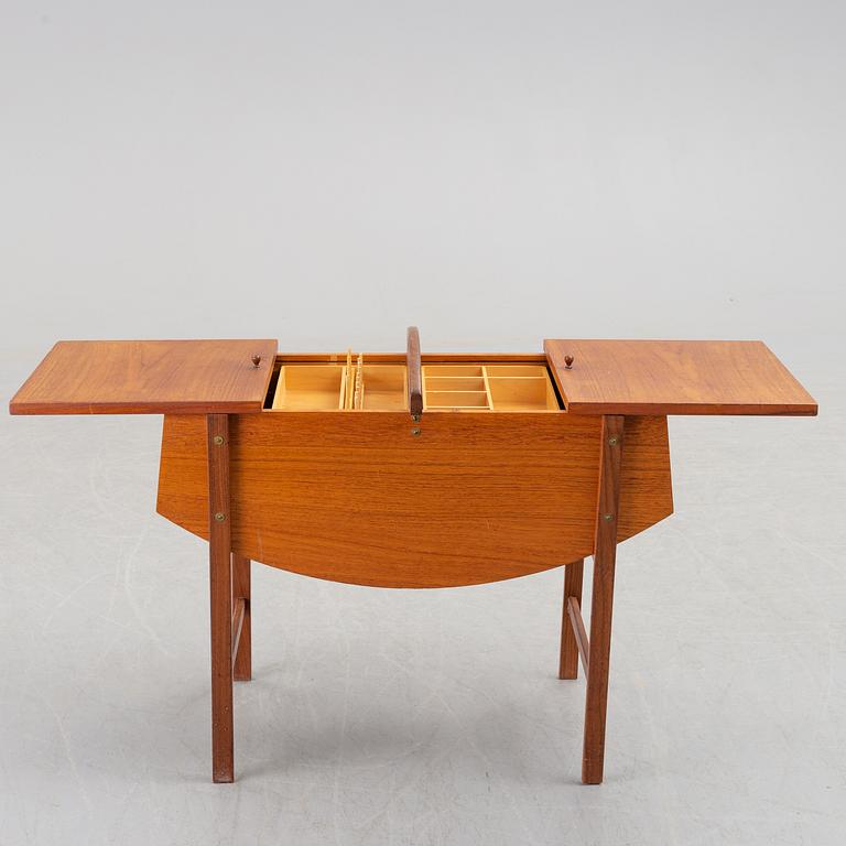 A mid 20th century teak sewing table.