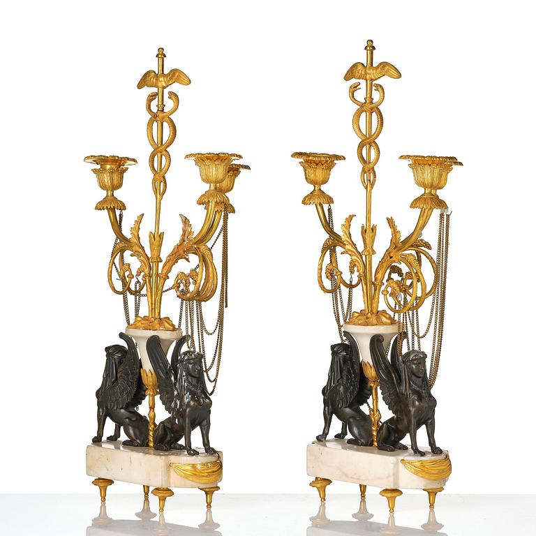 A pair of Louis XVI three lights Candelabra, Parisian works, in the manner of François Rémond, late 18th century.